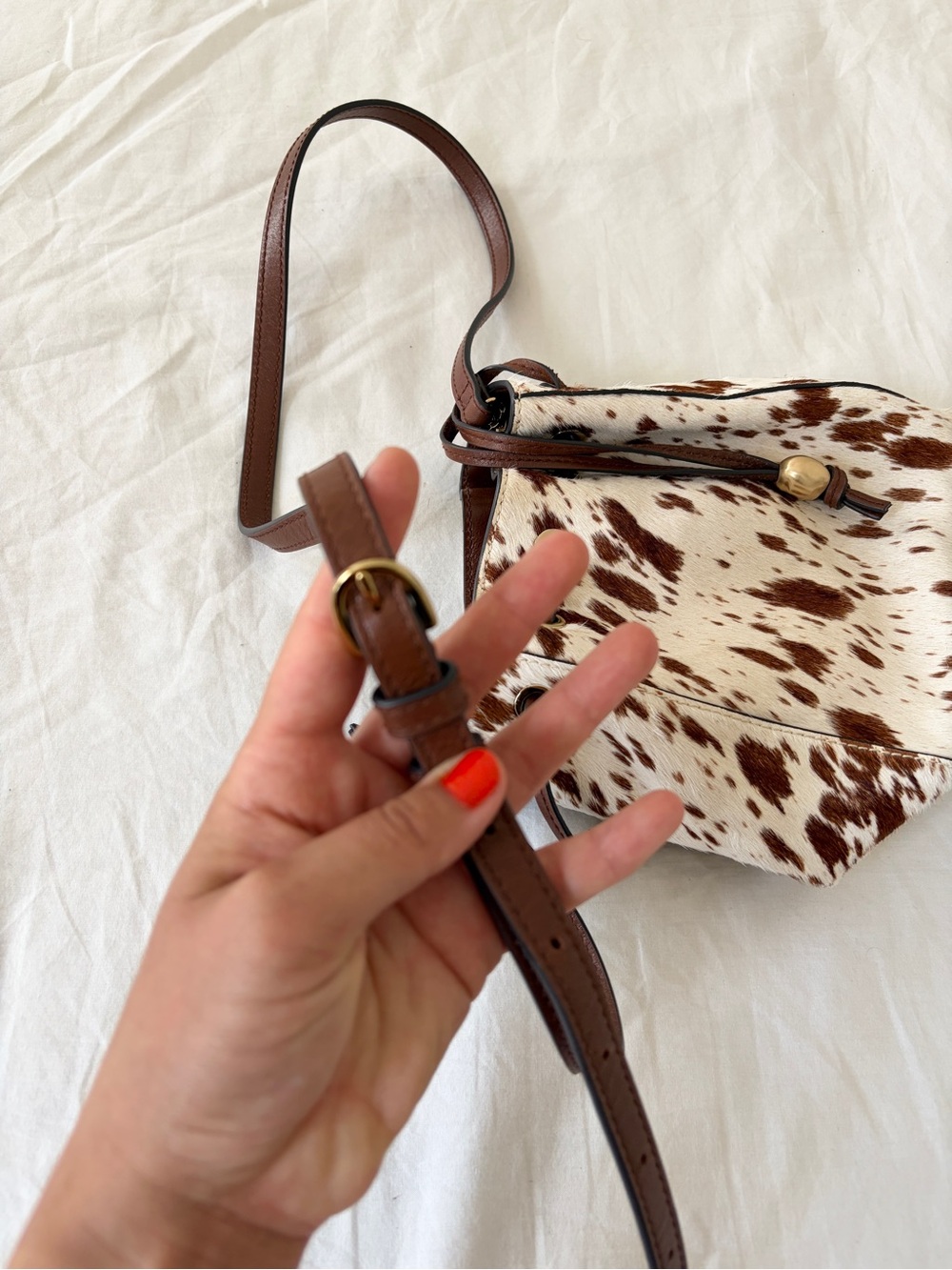 The Mini Drawstring Crossbody Bucket Bag Cow Print - Picture 6 of 11